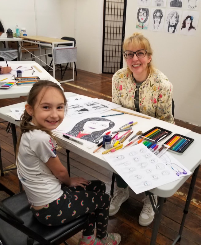 Art teacher Catherine Carter works with a student in her classroom at Catherine Carter Art School, Hatch Street Studios in New Bedford.