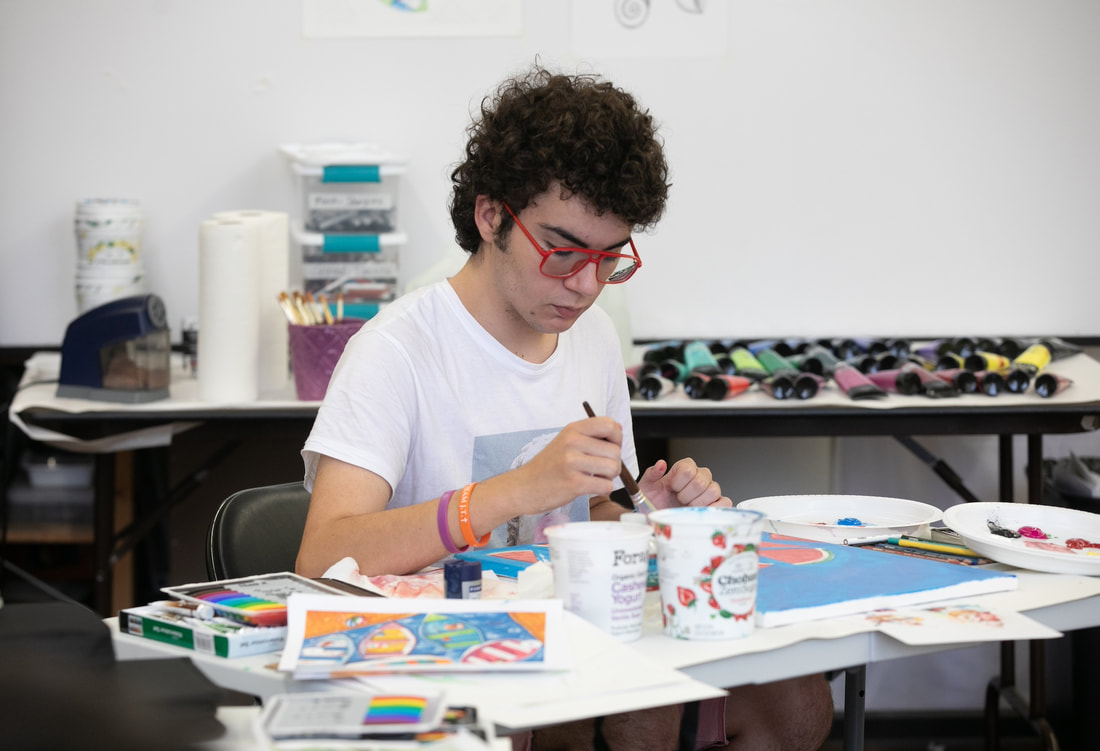 Student creating an acrylic painting at a teen art class during summer art camp at Catherine Carter Art School in New Bedford.